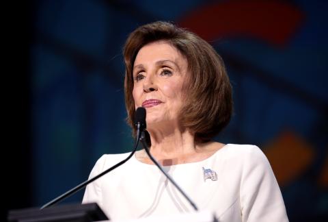 Nancy Pelosi speaking at a podium. 